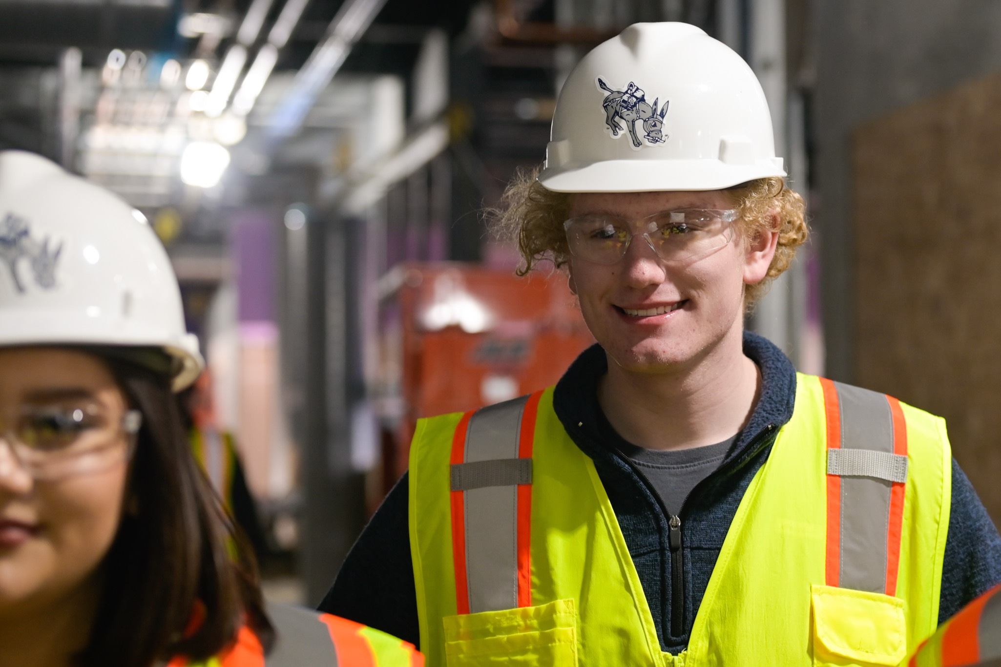 John Doe wearing construction vest and hard hat