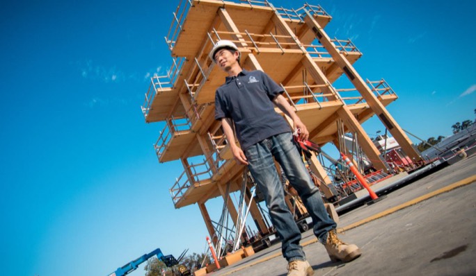 Student standing in front of lateral system
