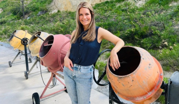 Student standing in front of concrete mixers